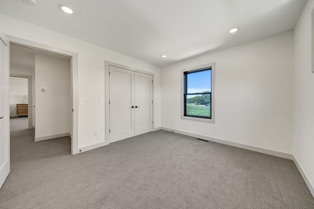 unfurnished bedroom with light carpet