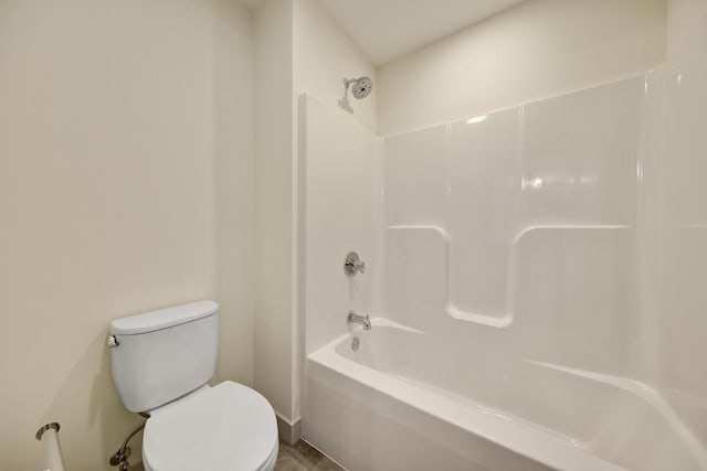 bathroom with toilet and bathing tub / shower combination