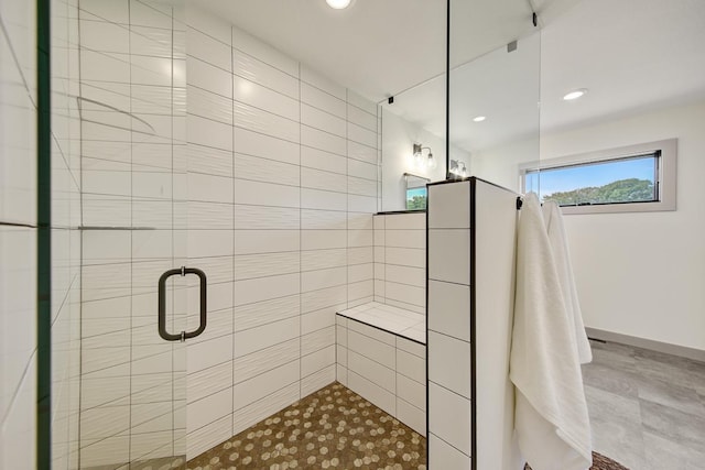 bathroom with a shower with door