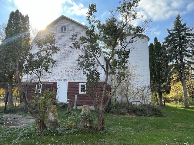 view of property exterior with a lawn