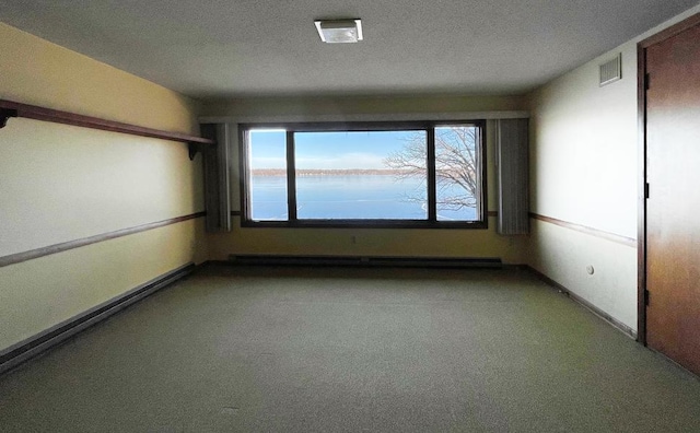 unfurnished room with a baseboard radiator, a textured ceiling, and carpet