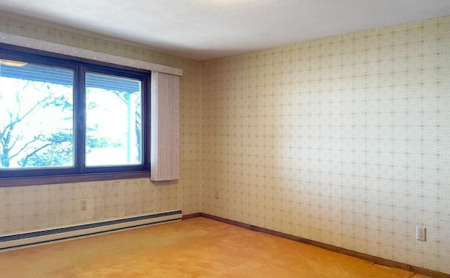 carpeted empty room featuring a baseboard radiator