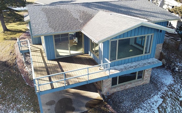 17850 Cedar Park Loop, Fergus Falls, MN 56537 - view of side of home with a shingled roof, board and batten siding, a sunroom, and a wooden deck