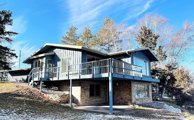 17850 Cedar Park Loop, Fergus Falls, MN 56537 - back of property featuring a patio, board and batten siding, and a wooden deck