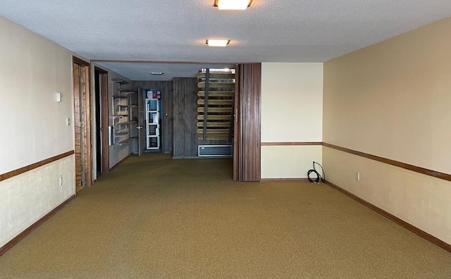 carpeted spare room with a textured ceiling