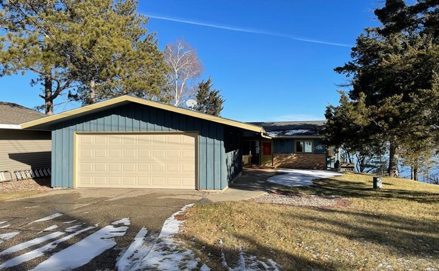 17850 Cedar Park Loop, Fergus Falls, MN 56537 - view of property exterior with board and batten siding, a garage, and a yard