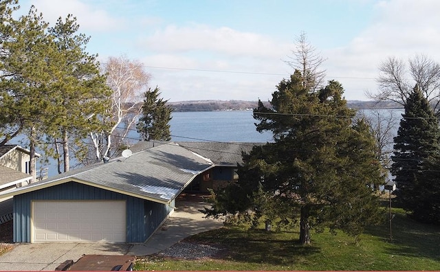 17850 Cedar Park Loop, Fergus Falls, MN 56537 - view of front facade featuring roof with shingles, a water view, and an attached garage