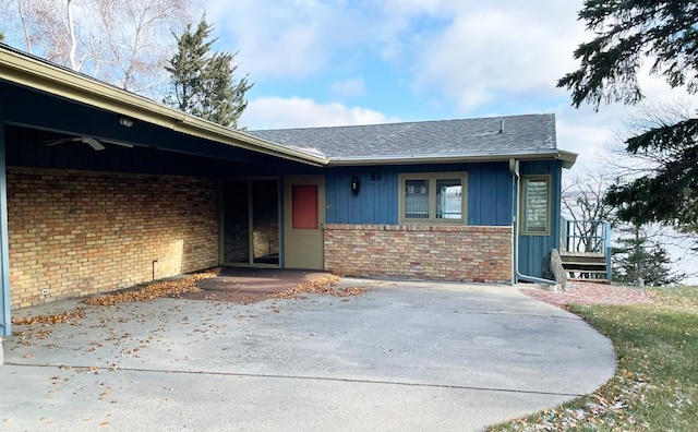 17850 Cedar Park Loop, Fergus Falls, MN 56537 - doorway to property featuring board and batten siding, brick siding, and a shingled roof