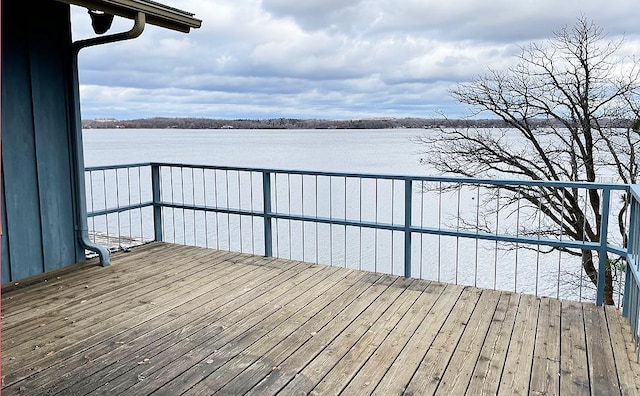 wooden terrace featuring a water view