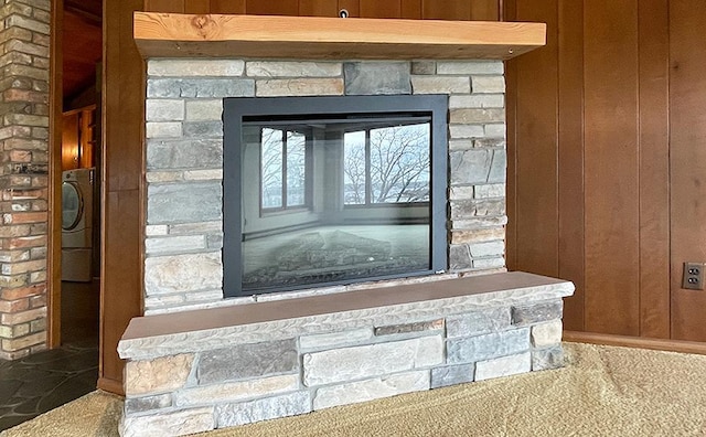 17850 Cedar Park Loop, Fergus Falls, MN 56537 - detailed view of a stone fireplace, wooden walls, and washer / clothes dryer