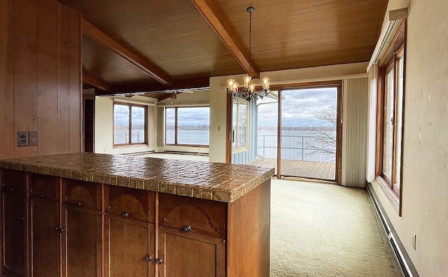 kitchen featuring a notable chandelier, wood ceiling, a wealth of natural light, and light colored carpet