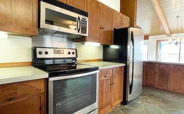 kitchen with an inviting chandelier, pendant lighting, vaulted ceiling with beams, and stainless steel appliances