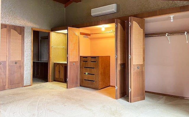 interior space with a wall mounted air conditioner and light colored carpet