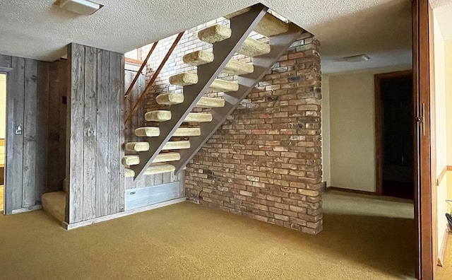 interior space with carpet flooring and a textured ceiling