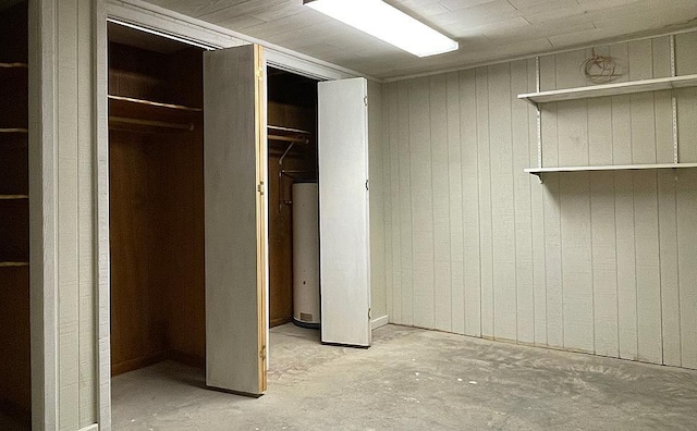 17850 Cedar Park Loop, Fergus Falls, MN 56537 - unfurnished bedroom with water heater, unfinished concrete flooring, and wood walls