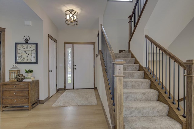 foyer entrance featuring an inviting chandelier and light hardwood / wood-style flooring