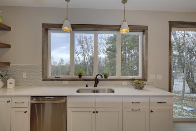 kitchen with white cabinets, dishwasher, sink, and a healthy amount of sunlight