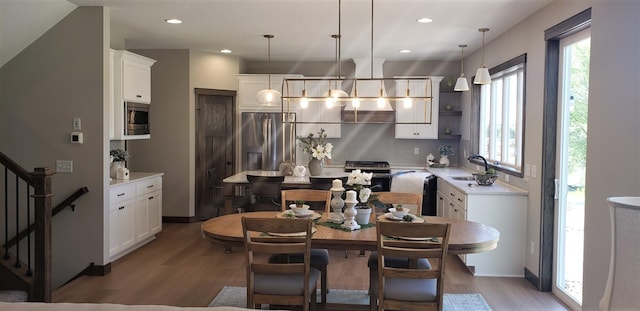 dining area with light wood-type flooring and sink