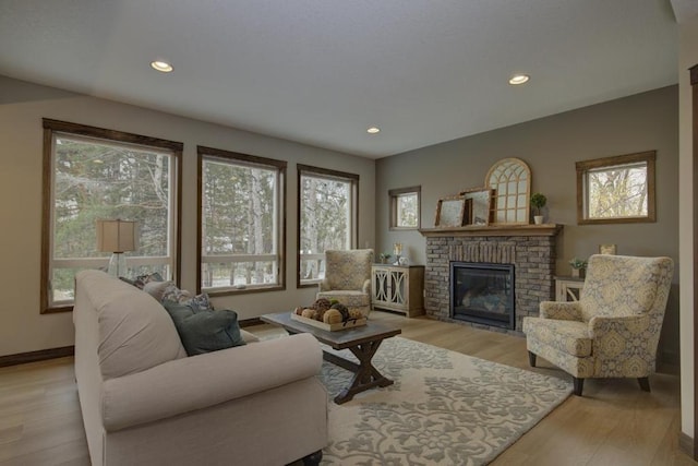 living room featuring a brick fireplace and light wood-type flooring