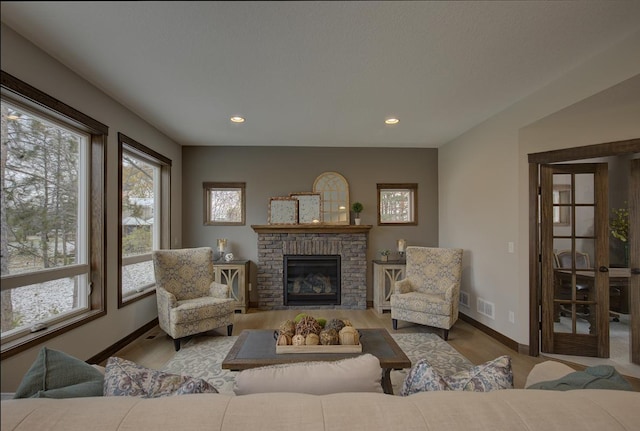 living room featuring light hardwood / wood-style flooring and a brick fireplace