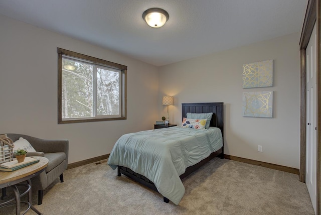 bedroom featuring light carpet