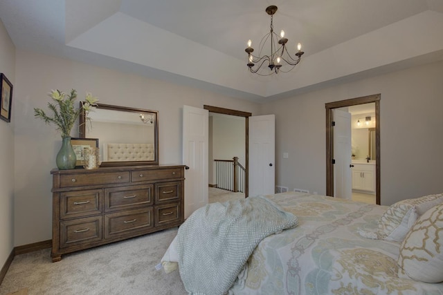 carpeted bedroom featuring connected bathroom, a chandelier, and a raised ceiling