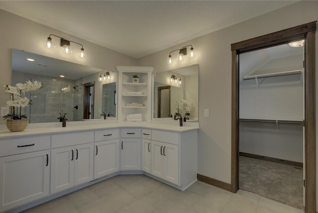 bathroom featuring an enclosed shower and vanity