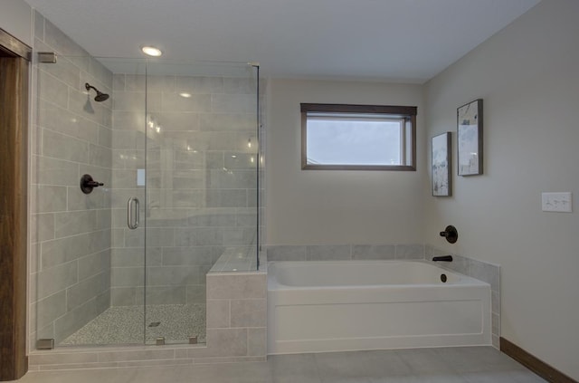 bathroom featuring independent shower and bath and tile patterned flooring