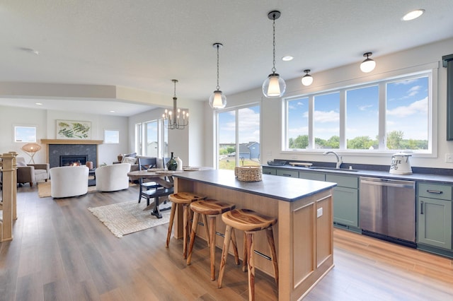 kitchen featuring light hardwood / wood-style floors, dishwasher, plenty of natural light, and a kitchen island