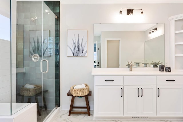 bathroom with vanity and a shower with door