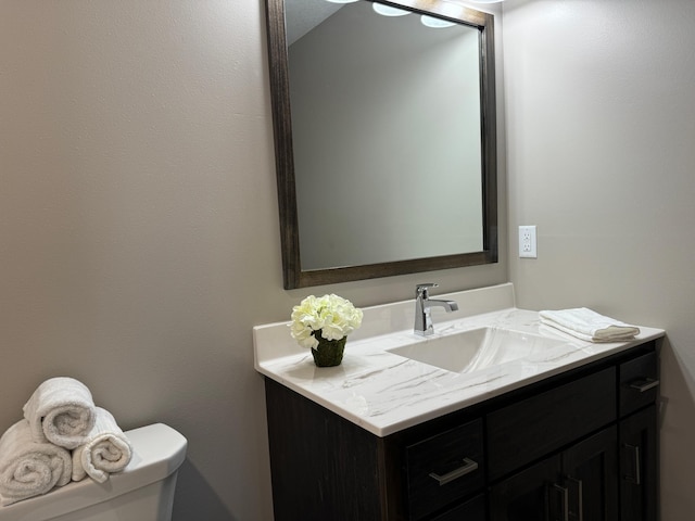 bathroom with toilet and vanity