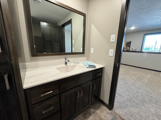 bathroom with vanity and a textured ceiling