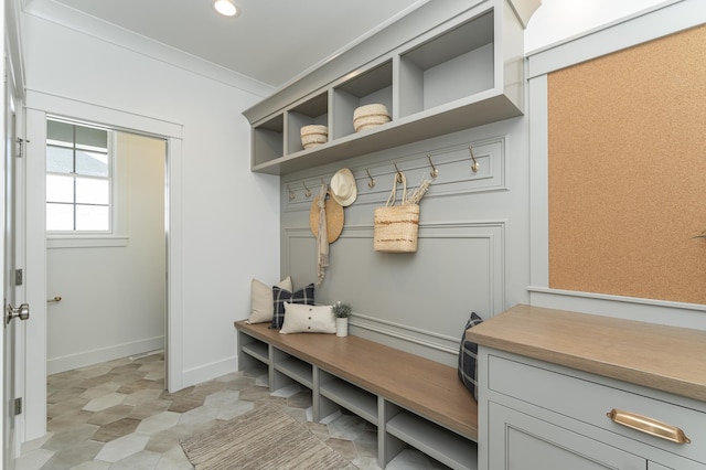 mudroom with ornamental molding, recessed lighting, and baseboards