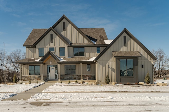 modern inspired farmhouse featuring roof with shingles and board and batten siding