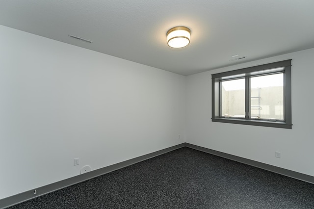 empty room featuring visible vents and baseboards