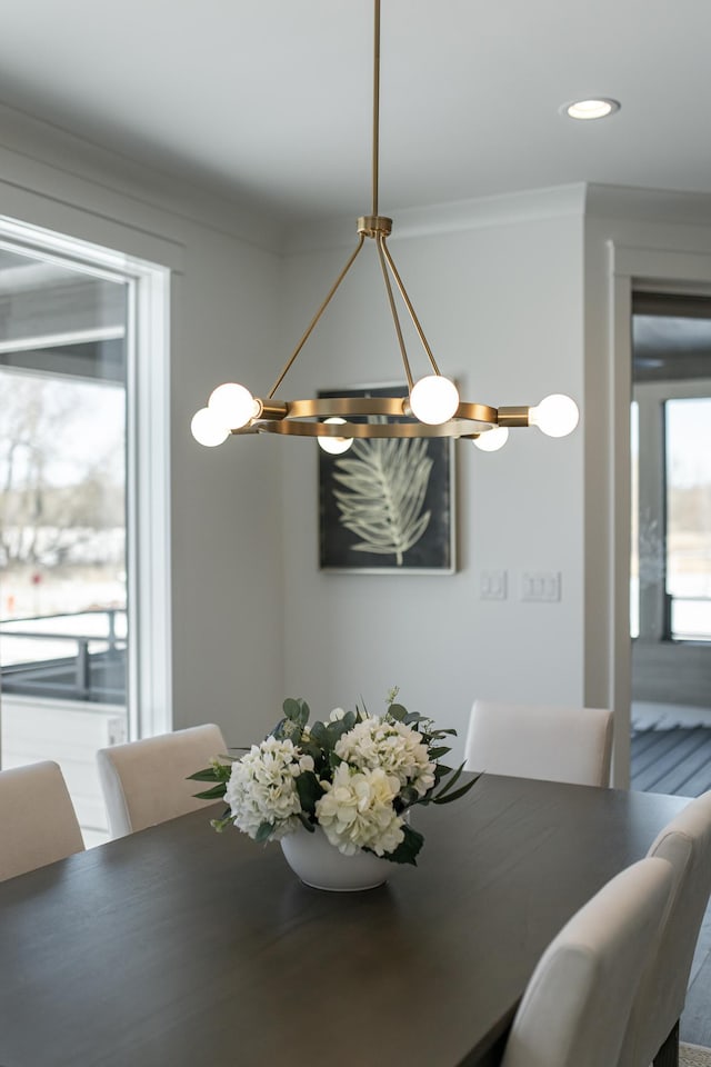 dining area with recessed lighting and crown molding