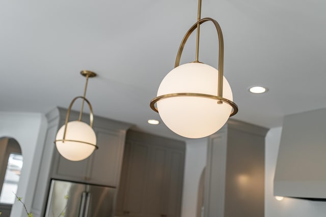 details featuring freestanding refrigerator and recessed lighting