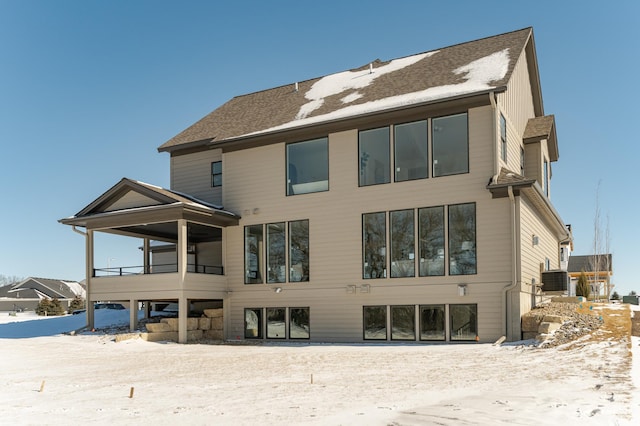 snow covered property featuring central air condition unit