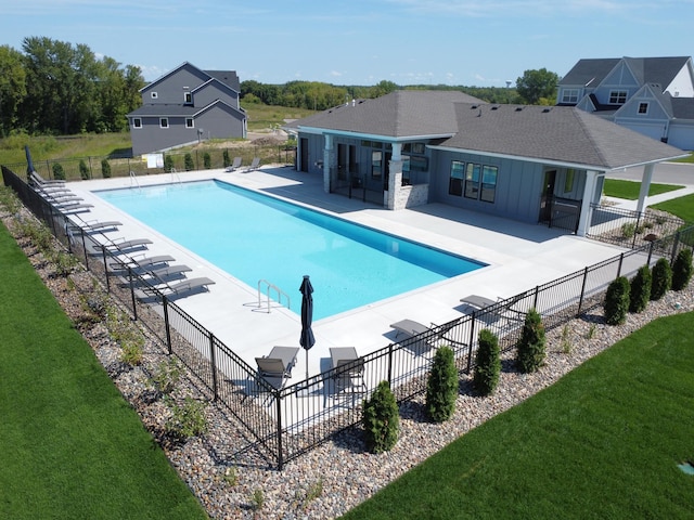 view of swimming pool featuring a yard and a patio