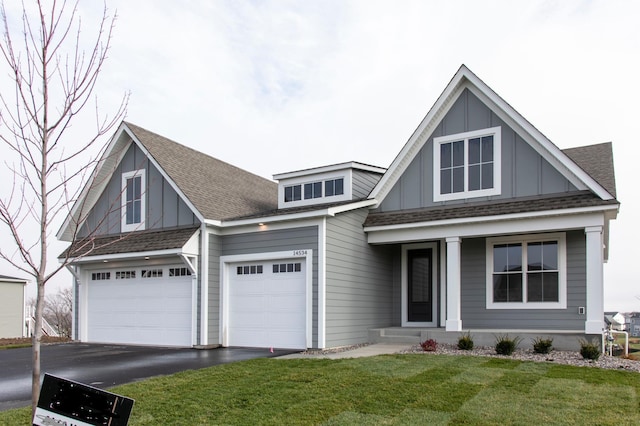 view of front of property with a garage and a front lawn