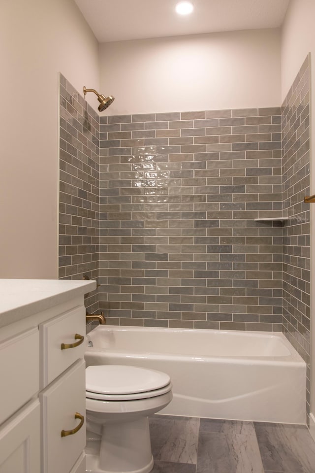 full bathroom with vanity, toilet, and tiled shower / bath combo