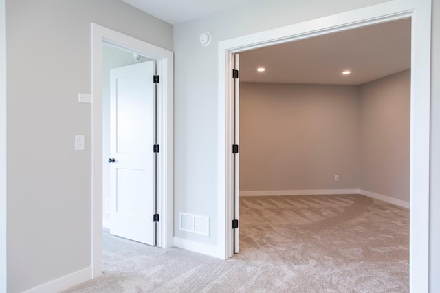 corridor with light colored carpet