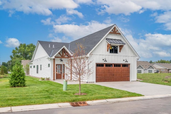 modern farmhouse style home with a garage and a front yard