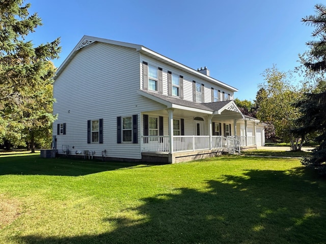 exterior space with a porch, a garage, cooling unit, and a lawn