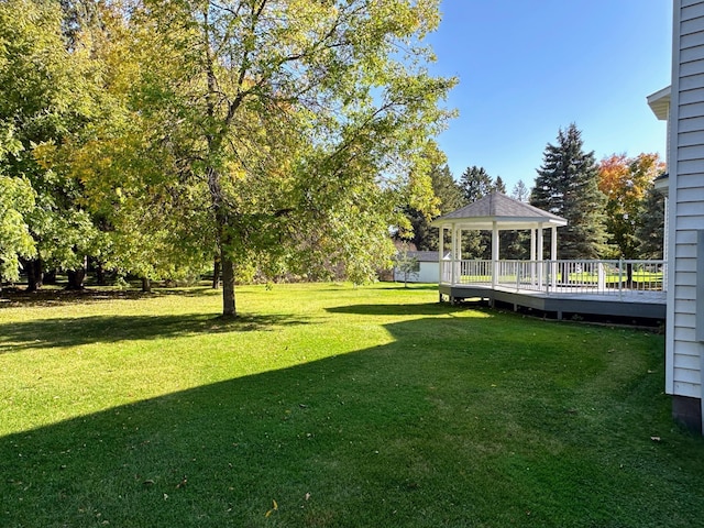 view of yard with a gazebo and a wooden deck