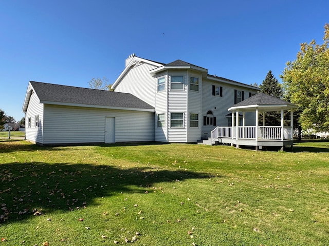 back of house with a yard and a wooden deck