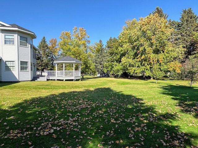 view of yard with a gazebo and a wooden deck