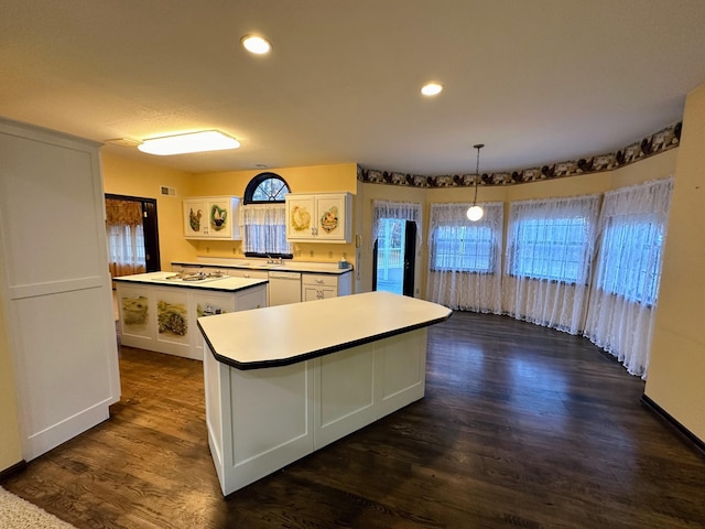 kitchen with white cabinetry, dishwasher, dark hardwood / wood-style flooring, decorative light fixtures, and a kitchen island