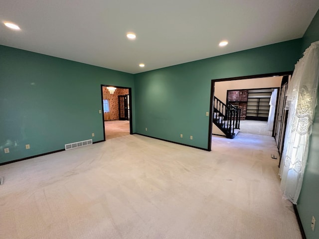 spare room with light colored carpet