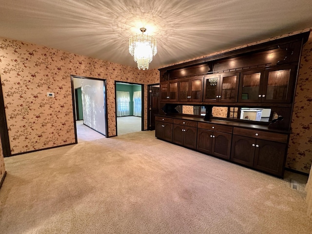 interior space featuring light colored carpet and an inviting chandelier